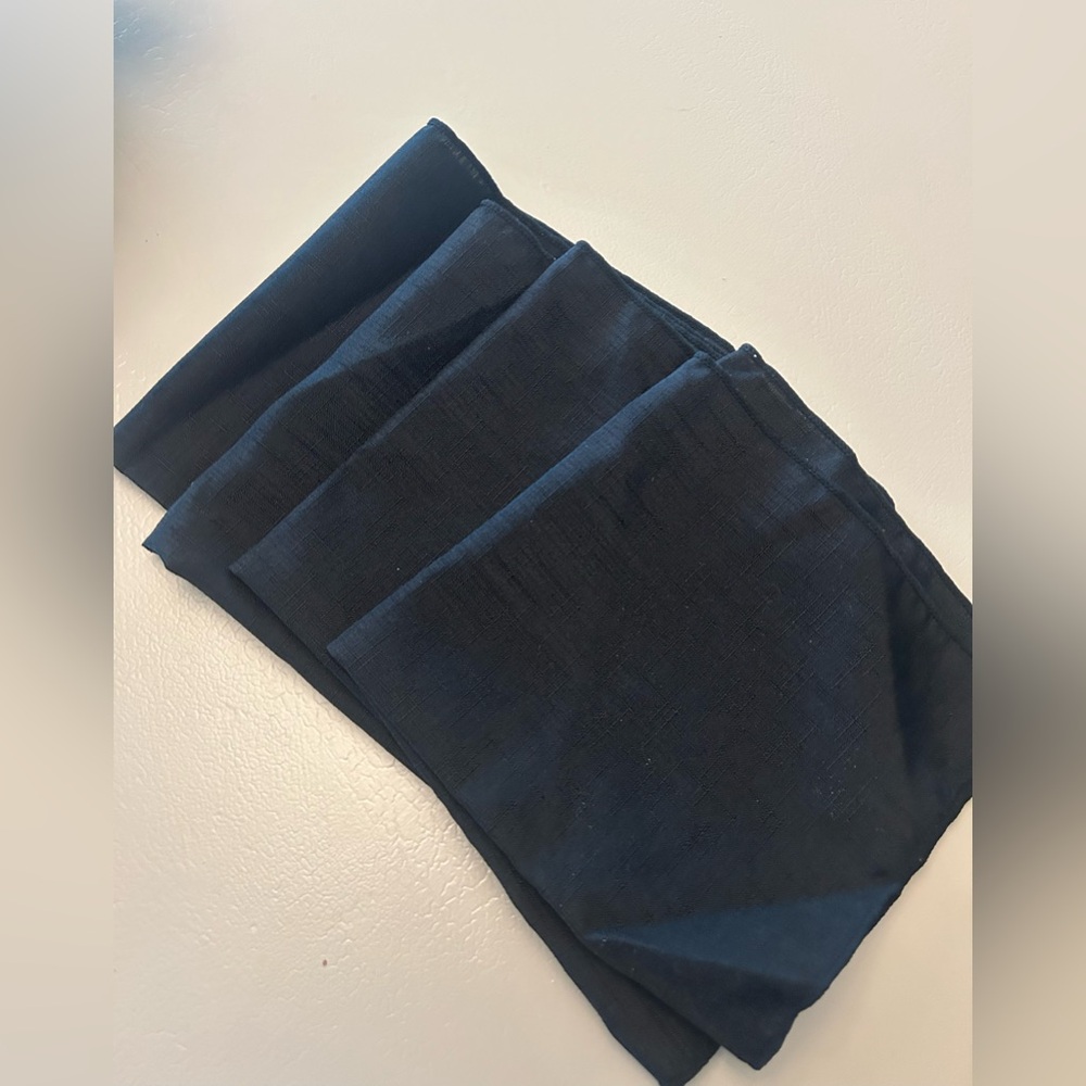 Four black cloth napkins